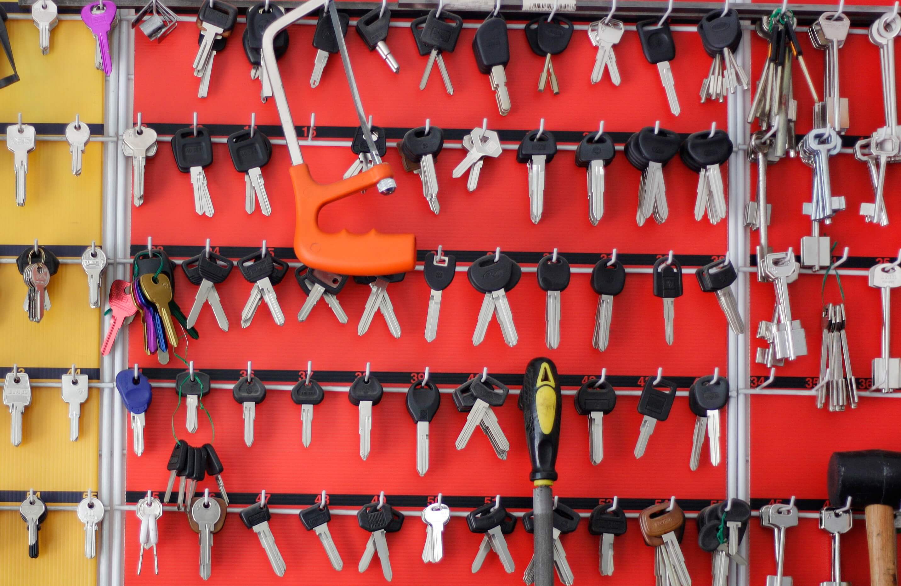 Wall of key blanks at a locksmith workshop ready to be cut