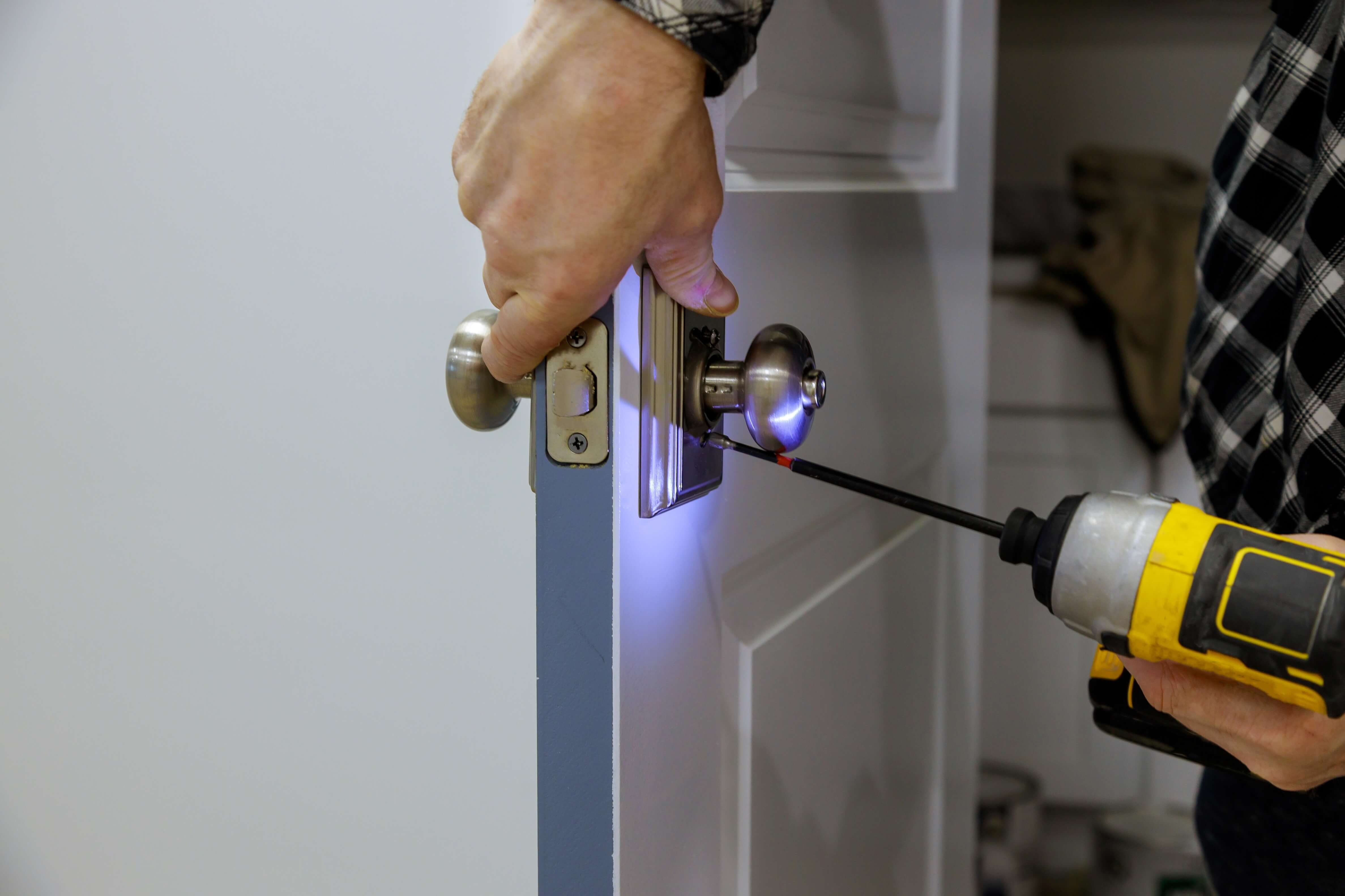 Locksmith repairing a damaged door lock after a break-in in Wodonga